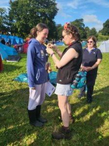 Kerrie MacDonald-Nethercott at a Girlguiding camp receiving her Leadership Qualification